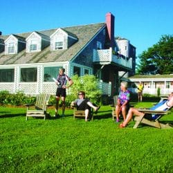 Bike tour guests relax in front of an inn