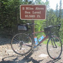 Road bicycle leaning against the sign that marks one mile in elevation above sea level, on Trail Ridge Road in Rocky Mountain National Park