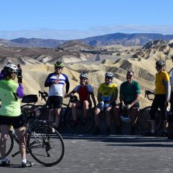 A group of cyclists pause at Zabriskie Point in Death Valley National Park, for a stunning desert view.