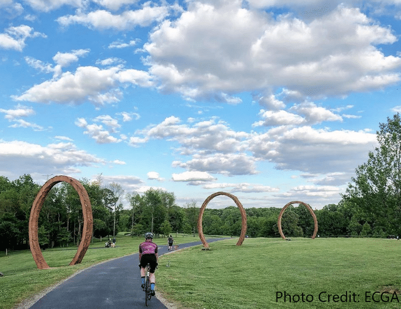 Biker on a trail through the Raleigh NCMA