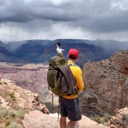 hiker overlooking grand canyon