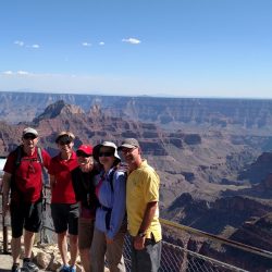 group of people in front of the crand canyon