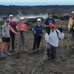 group of hikers next to a crater