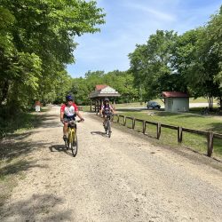 Two cyclists enjoy the crushed limestone KATY bike trail in Clifton City, Missouri