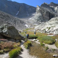 Hiking in the high alpine tundra towards Chasm Lake in Rocky Mountain National Park, in the shadow of Longs Peak