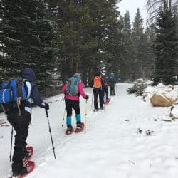 snowshoe hiking through the rocky mountains