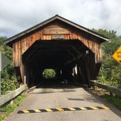 wood barn over a bridge in vermont