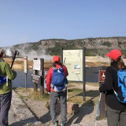 hikers at biscuit basin in yellowstone