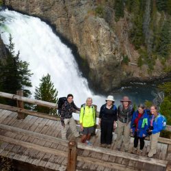 Hikers look up from the South Rim Trail overlook at Upper Falls of the Yellowstone River